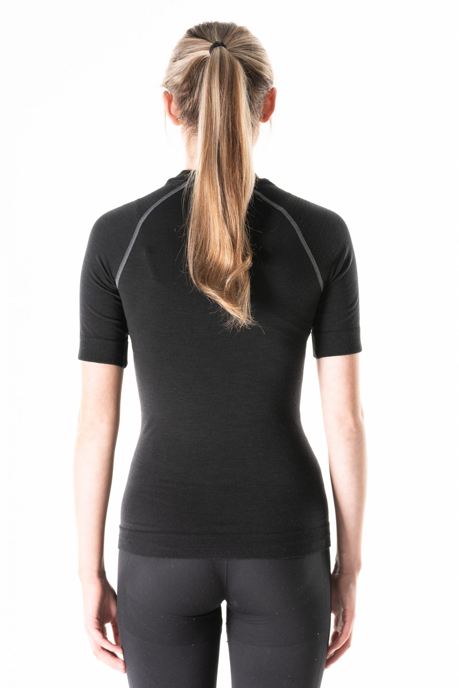 Model wearing Loomi Betatec short Sleeve Merino Base Layer, rear view.