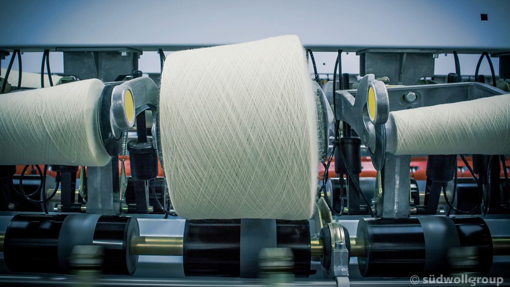 A roll of Merino yarn on an industrial knitting machine.