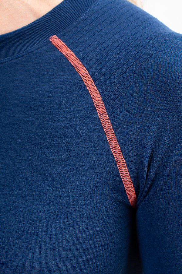 Model wearing Loomi Betatec Long Sleeve Merino Base Layer, shoulder detail.